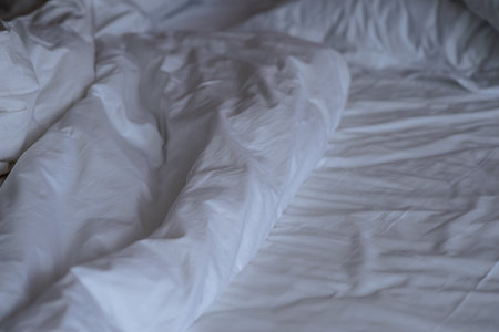 Pillows and blankets on the bed after waking upの写真素材