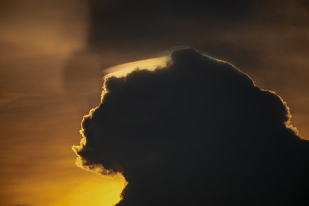 storm clouds with golden sunlight light backgroundの写真素材