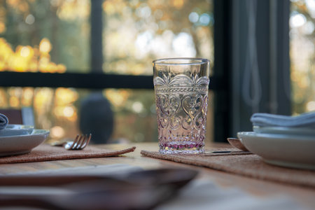 Dinner Table setting with Glasses and plates on table in restaurantの写真素材