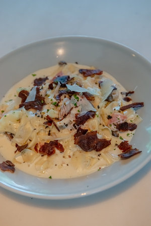 Truffle Alfredo Sauce: Delicately drizzled, elevating any dish with its exquisite flavor.の写真素材