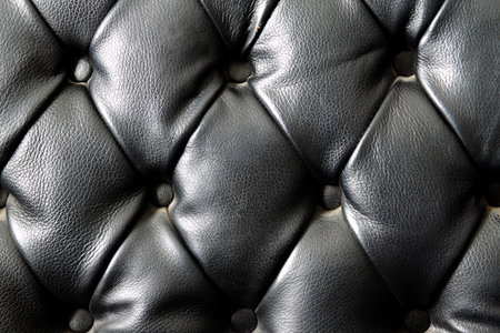 Closeup texture of vintage black leather sofa for backgroundの写真素材