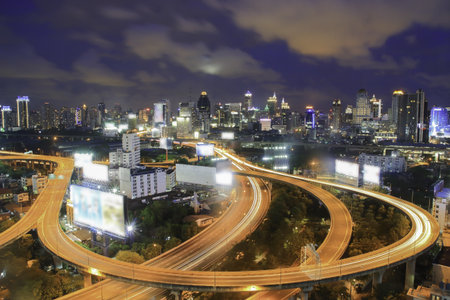 Freeway in night with cars light in modern cityの写真素材