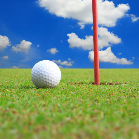 golf ball on lip of cupの写真素材