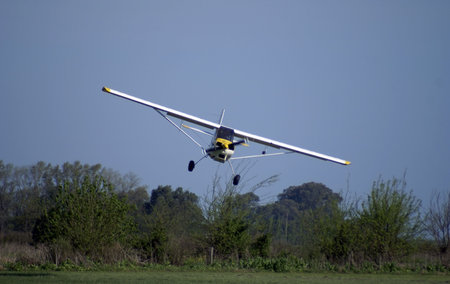 small plane landing in a rural runway