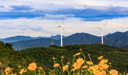 A wind turbine at the top of a mountainの写真素材