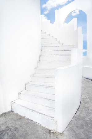  white spiral staircase and arch windowの写真素材