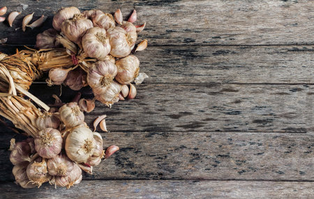 garlic on old wood textureの写真素材