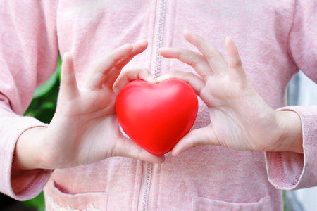 girl hold red heartの写真素材