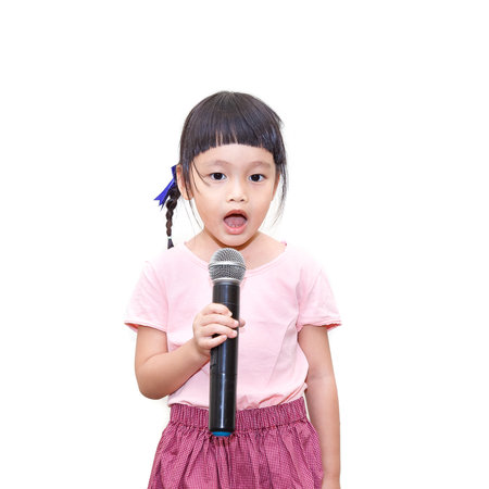 Asian kid speaking in microphoneの写真素材