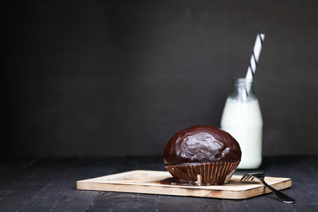 Chocolate muffins with milk bottle. Dark lightingの写真素材