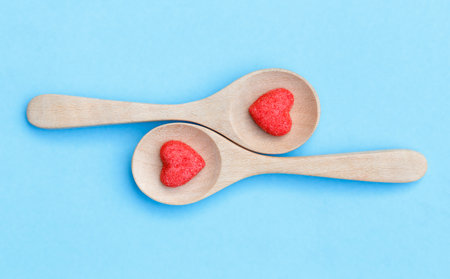 sugar candy shape heart on wooden spoonの写真素材