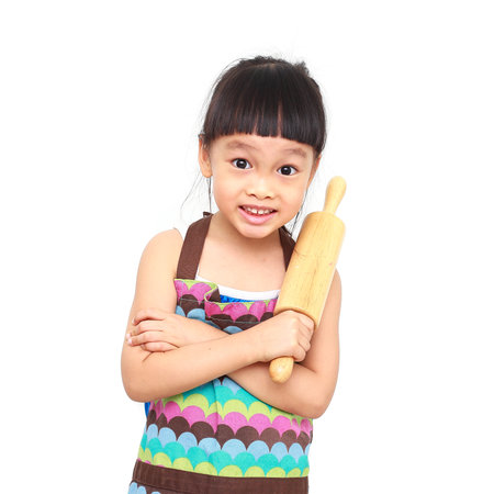 little asian girl chef cooking with colorful apron  on white backgroundの写真素材