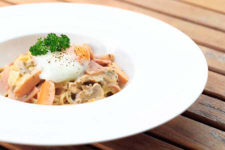 spaghetti carbonara with egg toppingの写真素材