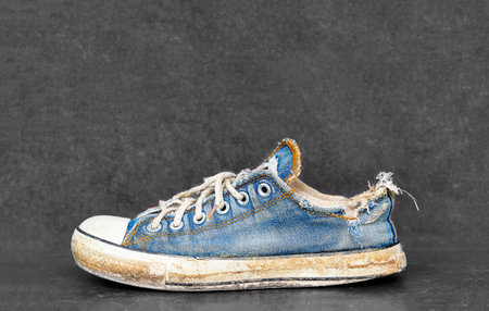 Old and dirty blue canvas sneakersの写真素材