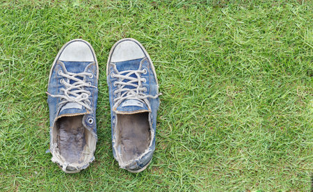 Old and dirty blue canvas sneakersの写真素材