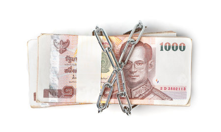 Thai baht currency with lock and chain, isolated on whiteの写真素材