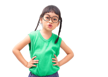 Little asian girl with arms akimbo isolated on white background