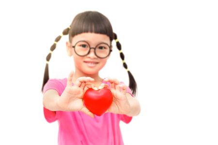 Little holding a red heart (valentine) isolated on white backgroundの写真素材