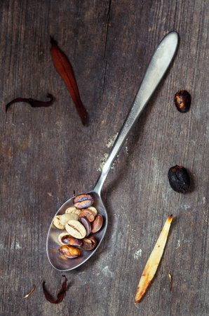 variety of coffee beans on spoon and wood backgroundの写真素材