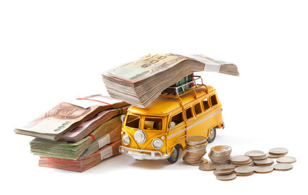Miniature  yellow bus carry money isolated on white backgroundの写真素材