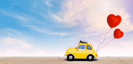 Miniature car with two red heart balloon. concept of love  wedding honeymoonの写真素材