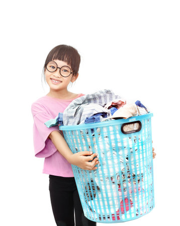 Asian little girl holding a big laundry basketの写真素材