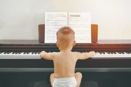 Little baby boy learn to play pianoの写真素材