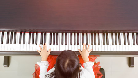 Little asian girl happy to play pianoの写真素材
