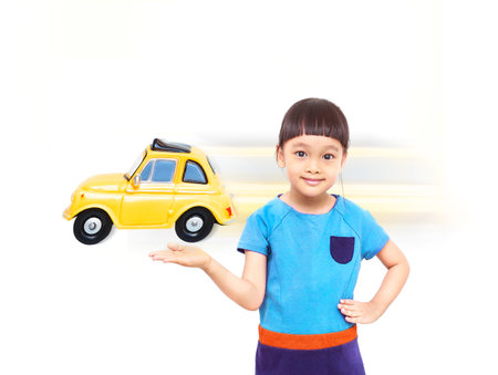 Little Asian girl smile and  holding a toy car  in hand, Isolated on white backgroundの写真素材
