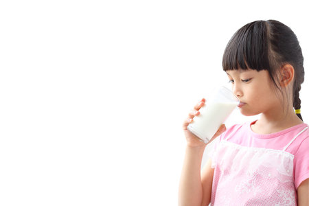 Asian girl drinking milk Isolated on white backgroundの写真素材
