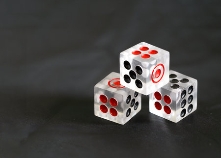 Transparent acrylic  dice isolated on dark background