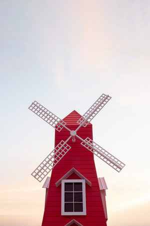 Red windmill isolated in dust sky backgroundの写真素材