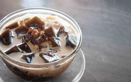 Grass jelly in sweet milk  serve on wood table backgroundの写真素材