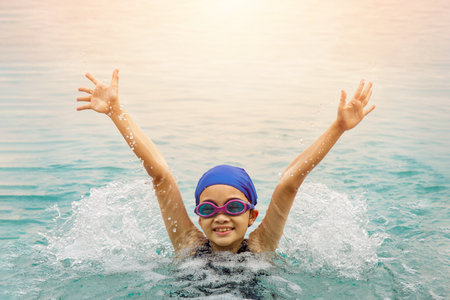 Happy girl swimmer raising her hand to be happy.の写真素材