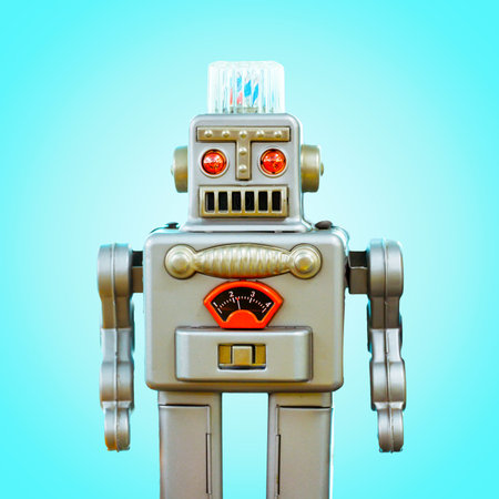 Retro robot tin toy isolated on blue backgroundの写真素材
