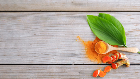 Turmeric powder close up with turmeric rootの写真素材