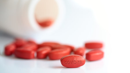 close up a red pill on a white backgroundの写真素材