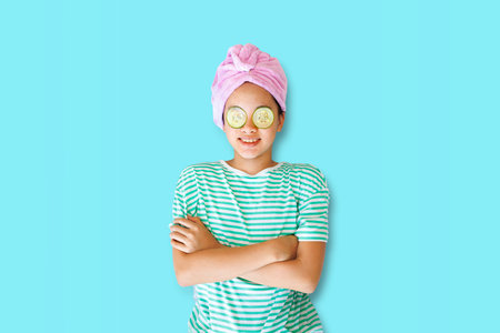 Young asian woman with cucumber mask on her face.の写真素材