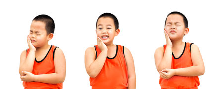 A little boy with a toothache makes various gestures. isolated on a white background.の写真素材