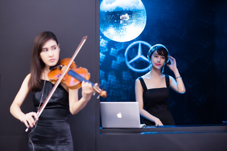 Blur Bangkok, Thailand  - April 06 2018 Unidentified model  Play music with violin and music from computer show in Bangkok International Motor Show in Bangkok, Thailandのeditorial素材