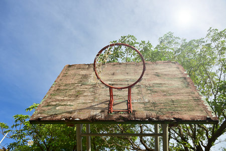 Basketball court  with old wood backboard.blue sky and white clouds on background. Old Basin Stadiumの写真素材