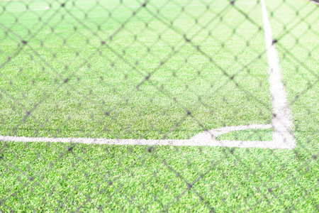 white line football corner on green fieldの写真素材