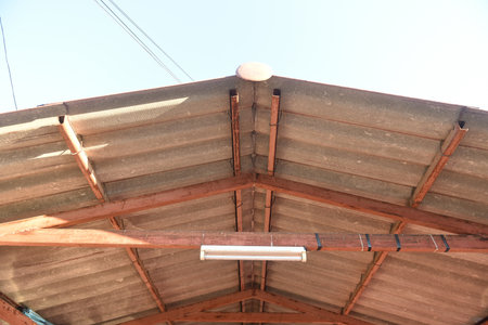House in the village, brown tile roof.