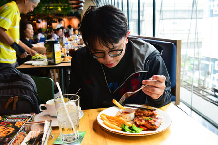 Bangkok Thailand August 03 2019 Blur Delicious salmon fish roasted steak in blue plate. with fresh...