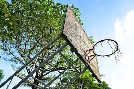 Basketball court  with old wood backboard.blue sky and white clouds on background. Old Basin Stadiumの写真素材