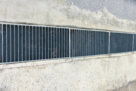 The water drain made from steel surrounded by concrete.
