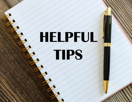 Top view of a pen with Helpful Tips written on a notebook.の写真素材
