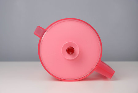 Red jug isolated on a grey and white background.の写真素材