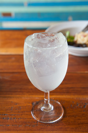 Drink with lime soda in a wine glass の写真素材