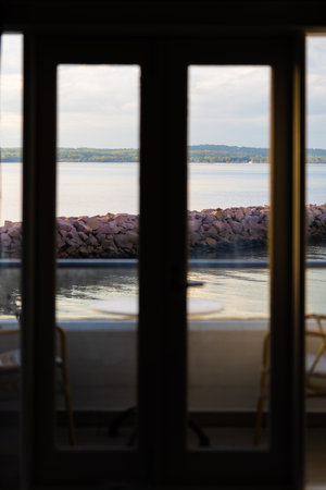 View of the sea through the window in the evening